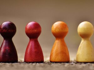 four wooden pawns in different colours