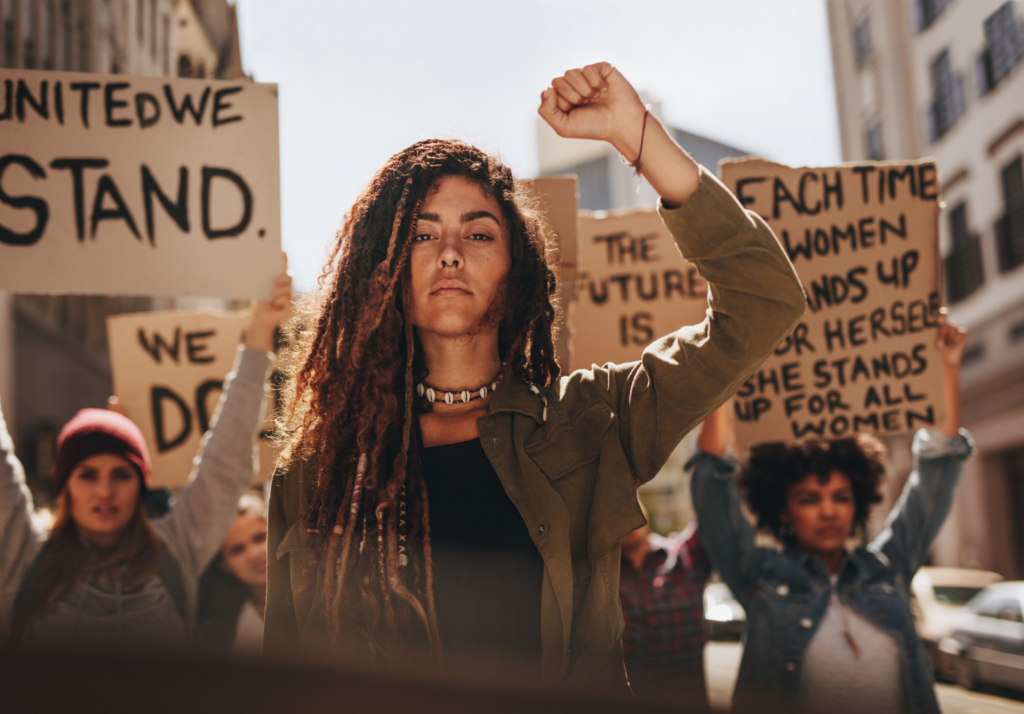 a woman protesting with many others in solidarity. Photo by Jacob Lund.